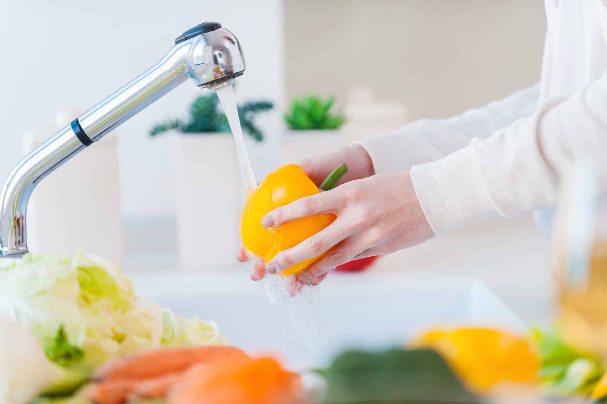 Woman washing vegetables